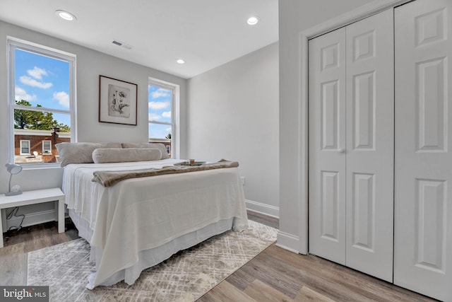 bedroom with light wood-type flooring and a closet