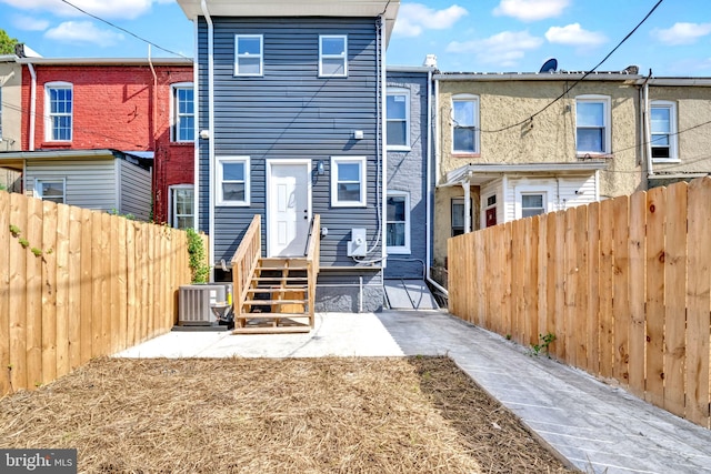 back of house with a patio area and central AC unit