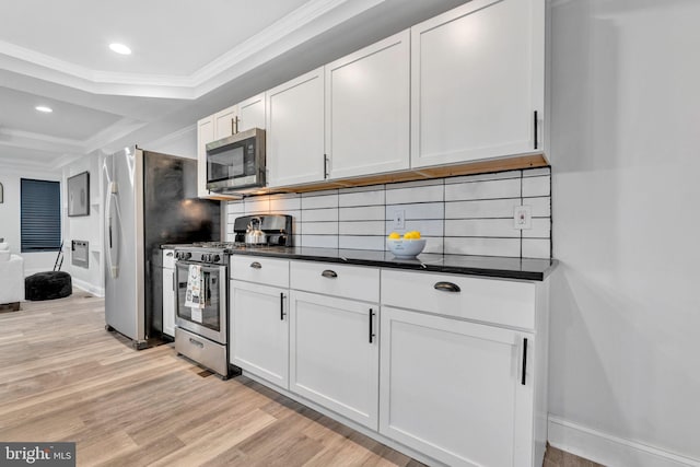 kitchen with stainless steel appliances, crown molding, light hardwood / wood-style floors, and white cabinetry