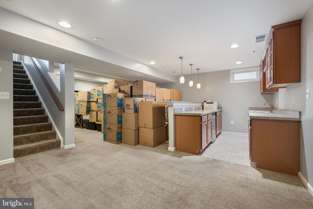 kitchen featuring pendant lighting, light colored carpet, and sink