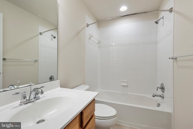 full bathroom featuring tiled shower / bath, vanity, and toilet