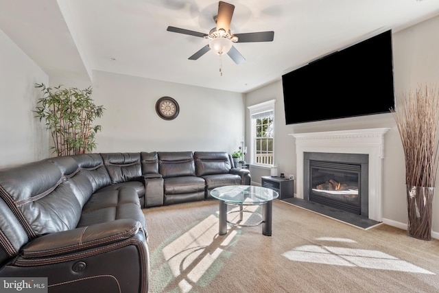 carpeted living room with ceiling fan