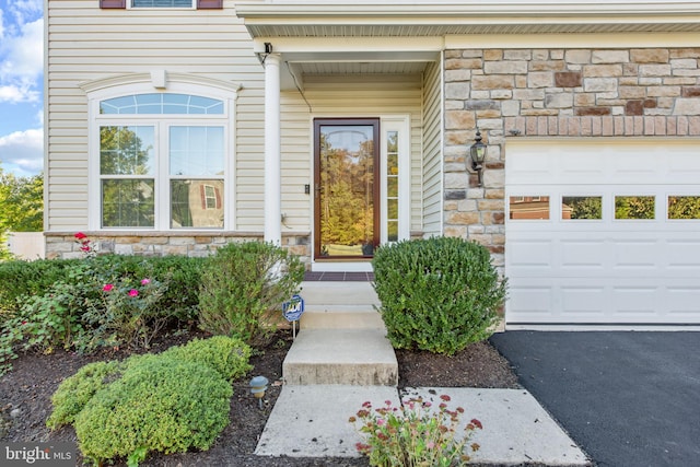 view of exterior entry featuring a garage