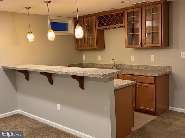 bar featuring decorative light fixtures, sink, and light carpet