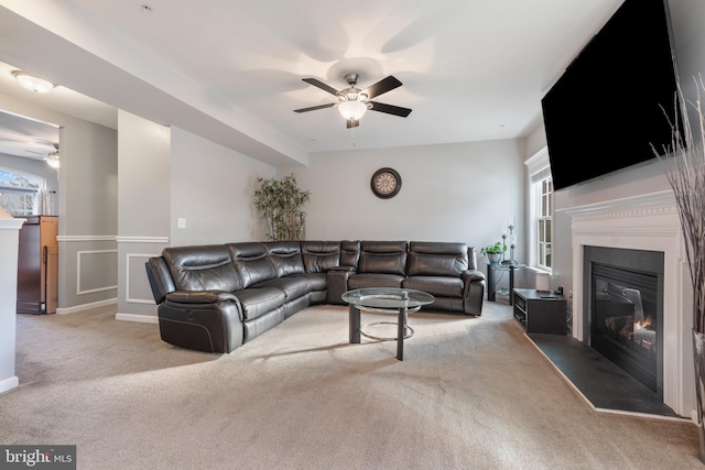 carpeted living room with plenty of natural light and ceiling fan