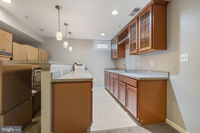 kitchen featuring light tile patterned floors, decorative light fixtures, stainless steel refrigerator, and sink