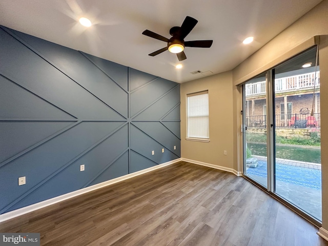 spare room with ceiling fan and wood-type flooring