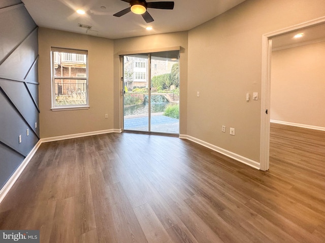 empty room featuring hardwood / wood-style floors and ceiling fan