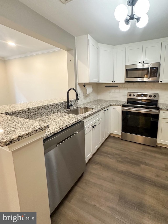 kitchen featuring dark hardwood / wood-style flooring, sink, stainless steel appliances, and white cabinets