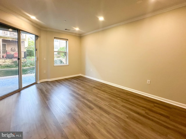 unfurnished room with dark wood-type flooring and ornamental molding