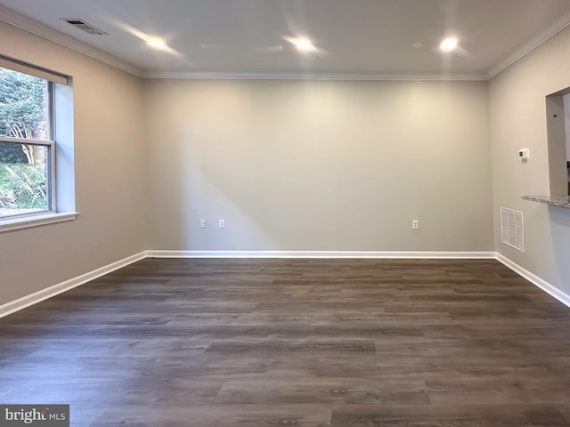 unfurnished room featuring crown molding and dark wood-type flooring