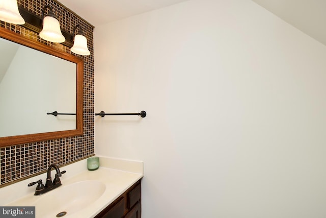 bathroom featuring decorative backsplash and vanity