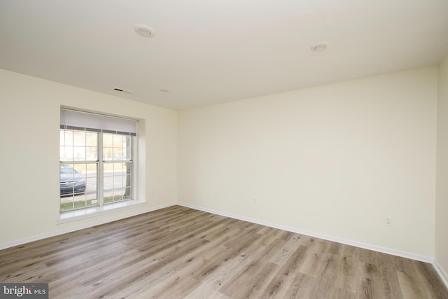 empty room with light hardwood / wood-style floors