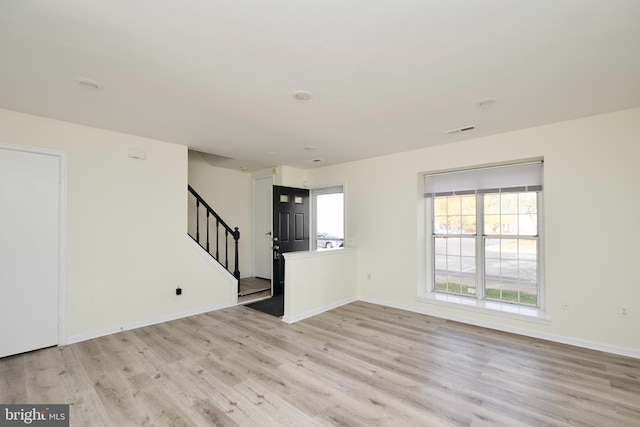 unfurnished living room featuring light wood-type flooring