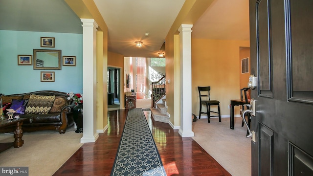 entryway with decorative columns and dark hardwood / wood-style floors