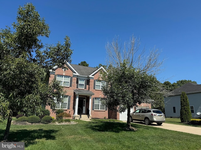 view of front of property with a garage and a front lawn