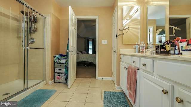 bathroom with tile patterned flooring, walk in shower, and vanity