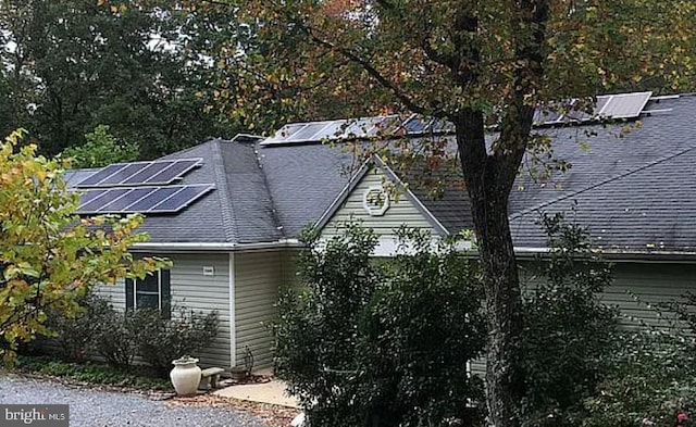 view of property exterior with solar panels