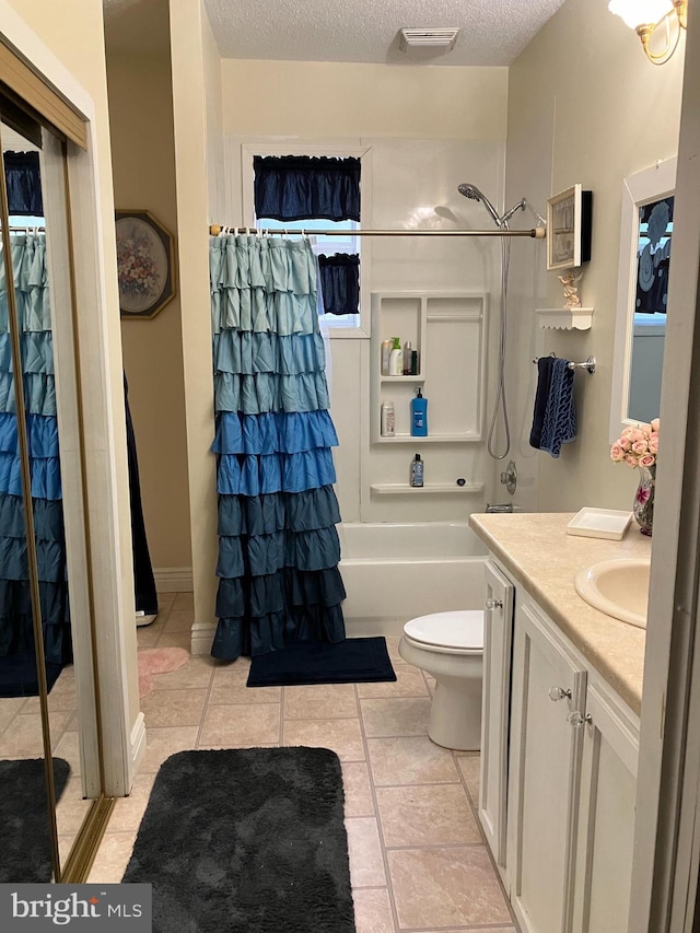 full bathroom with vanity, tile patterned floors, a textured ceiling, and toilet