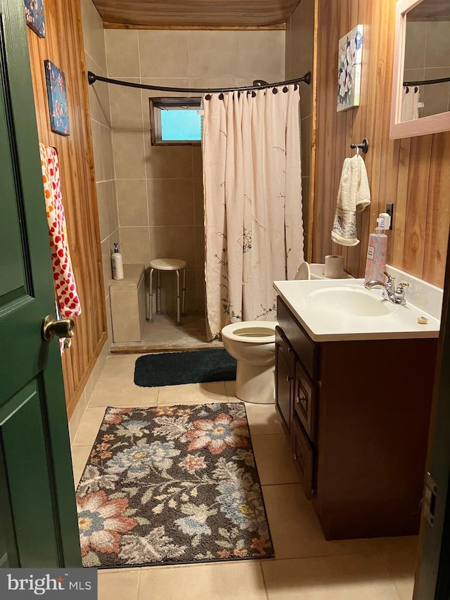 bathroom featuring tile patterned flooring, vanity, walk in shower, and toilet