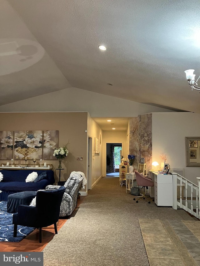 carpeted living room featuring lofted ceiling, a textured ceiling, and an inviting chandelier