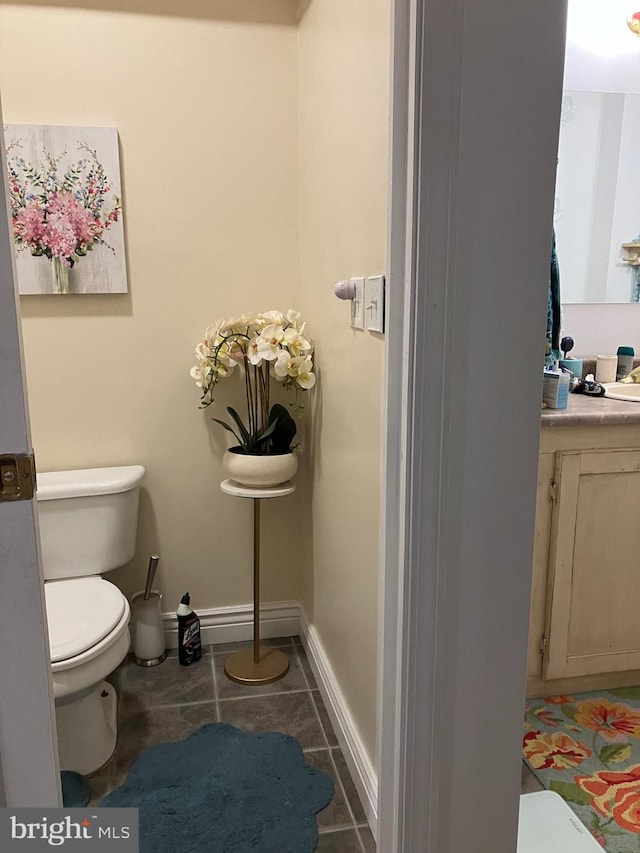 bathroom with vanity, toilet, and tile patterned flooring