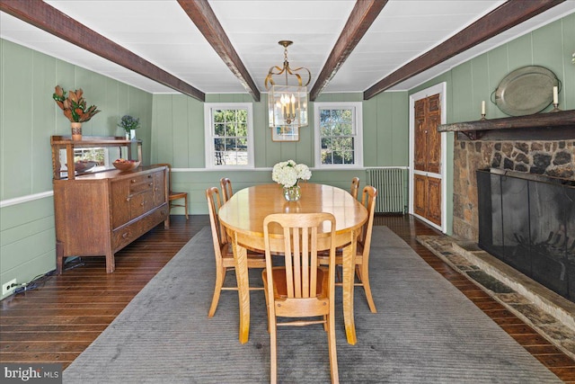 dining space featuring beamed ceiling, a fireplace, an inviting chandelier, and dark hardwood / wood-style flooring