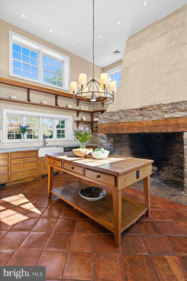 tiled dining space with sink and an inviting chandelier