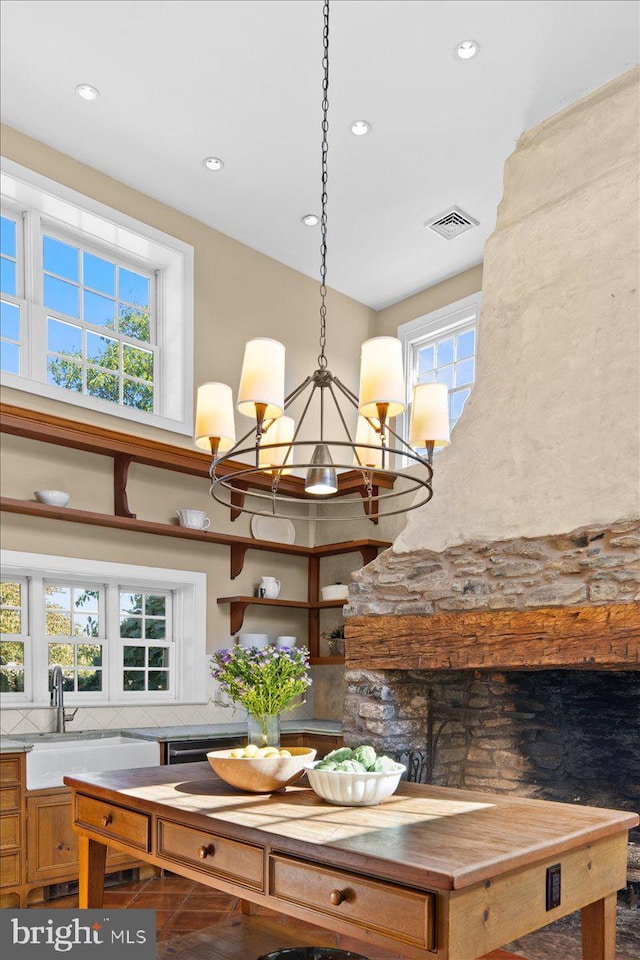 details with backsplash, sink, and a chandelier