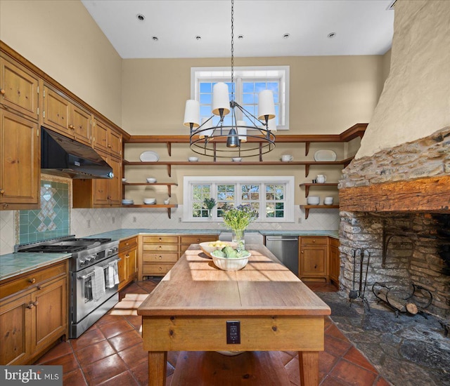 kitchen featuring tasteful backsplash, a center island, stainless steel appliances, decorative light fixtures, and a chandelier