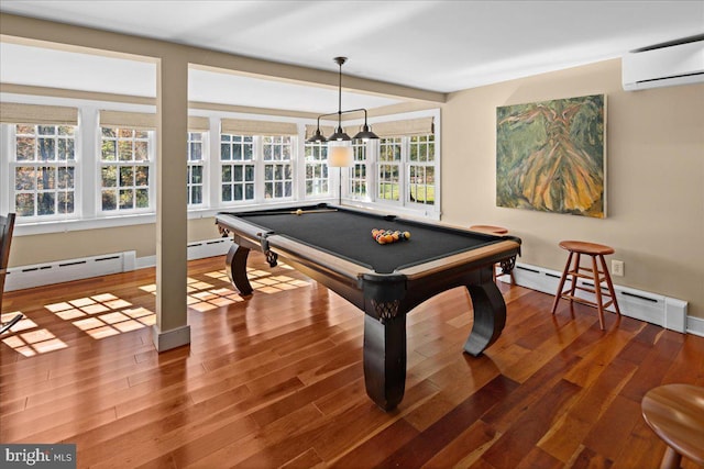 rec room featuring billiards, wood-type flooring, a wealth of natural light, and a wall unit AC