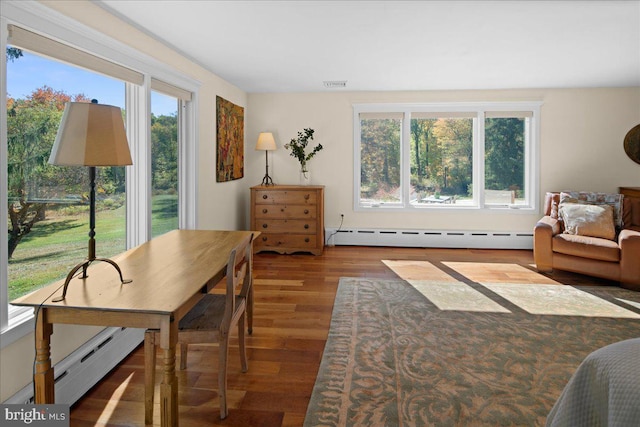 interior space featuring baseboard heating and wood-type flooring