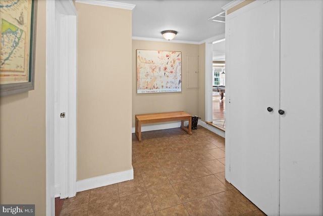 hallway with crown molding and tile patterned flooring