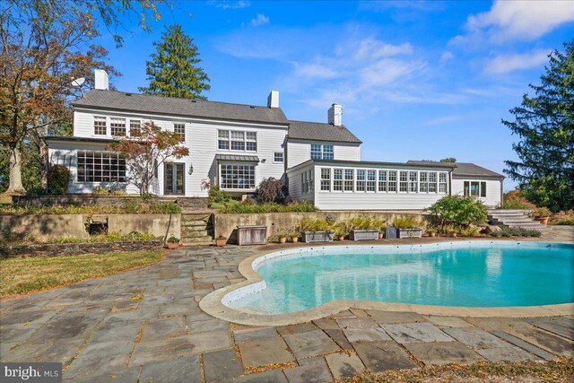 rear view of property featuring a patio