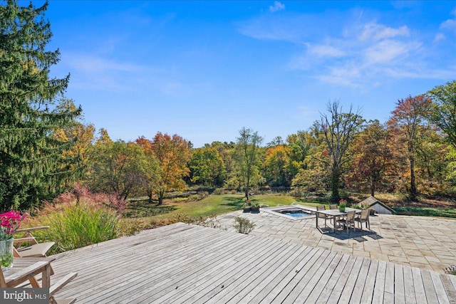 wooden terrace featuring a patio and a swimming pool with hot tub