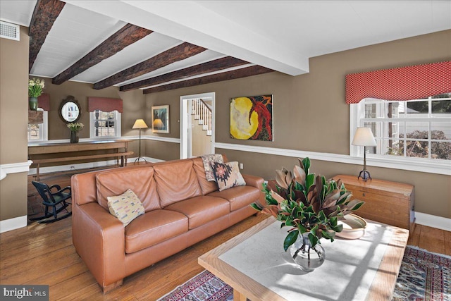 living room featuring hardwood / wood-style flooring and beamed ceiling