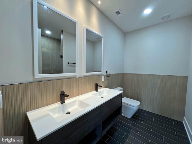 bathroom with vanity, a shower, and toilet