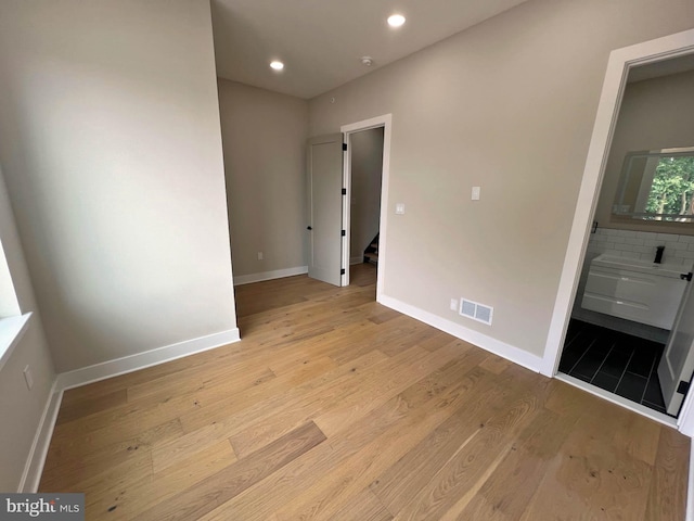 spare room featuring light hardwood / wood-style floors