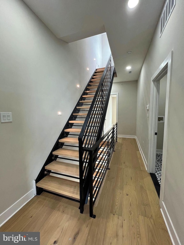 staircase with wood-type flooring