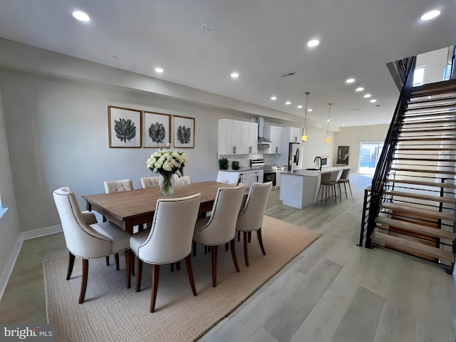 dining space with light hardwood / wood-style floors