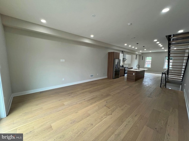 interior space with light hardwood / wood-style floors and sink