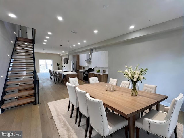 dining space with light hardwood / wood-style flooring