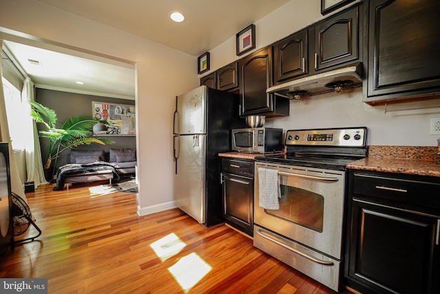 kitchen with crown molding, appliances with stainless steel finishes, light wood-type flooring, and extractor fan