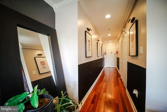 hallway featuring hardwood / wood-style flooring and crown molding