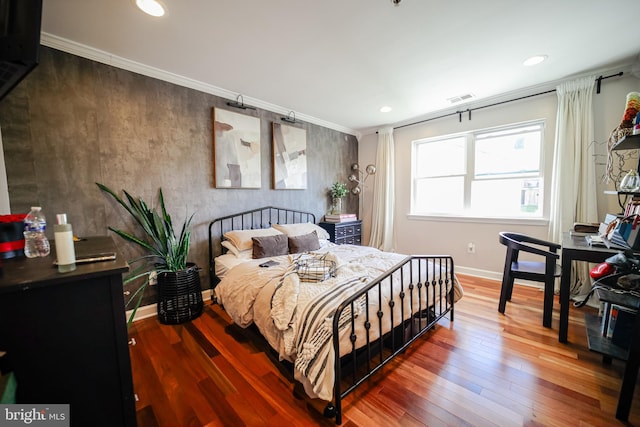 bedroom with wood-type flooring and crown molding