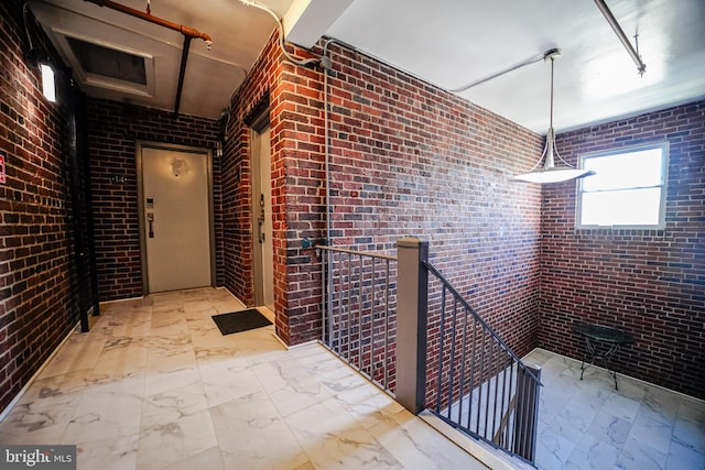 interior space featuring brick wall