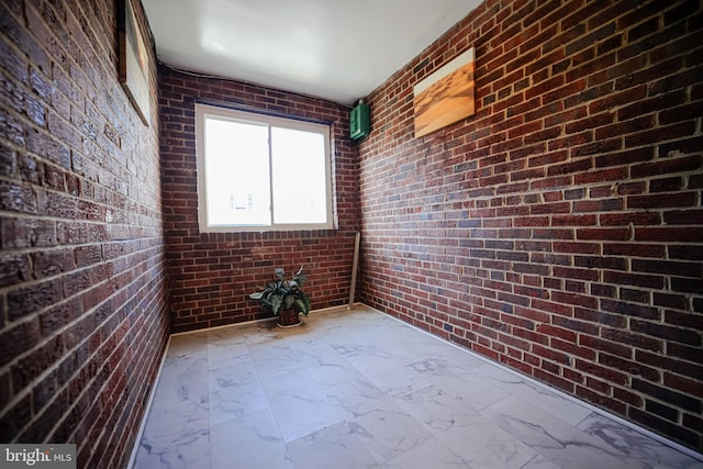 spare room with brick wall