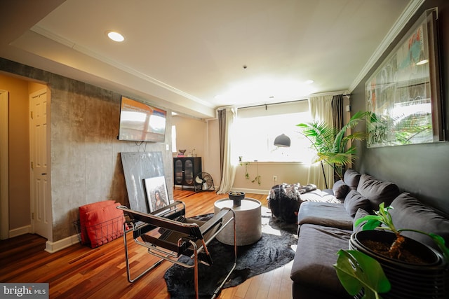 living room featuring crown molding and hardwood / wood-style flooring