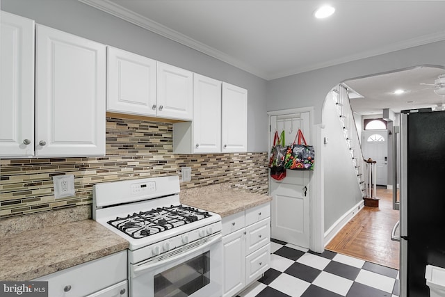 kitchen featuring ornamental molding, white cabinets, and white gas stove