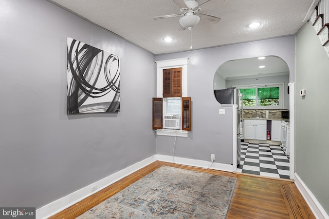 corridor with ornamental molding, sink, a textured ceiling, and dark hardwood / wood-style flooring